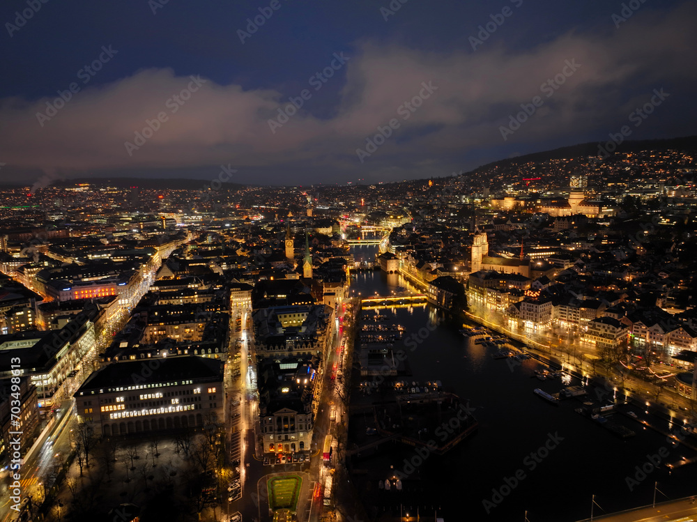 Aerial view of Swiss City of Zürich with the old town, cityscape, skyline, Limmat River and city lights on a dark winter night. Photo taken January 5th, 2024, Zurich, Switzerland.