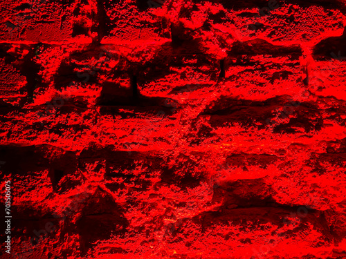 Texture of a brick wall with red lighting. Background for design, decor, banners.