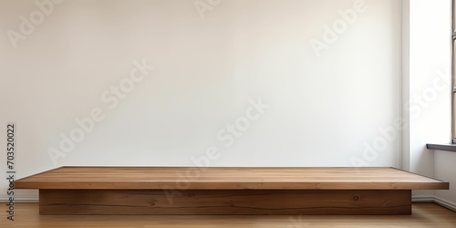  A brown and empty wooden table in front of a white wall, presentation space background