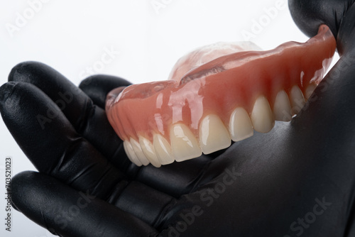 Upper complete denture on hand. © RoYam