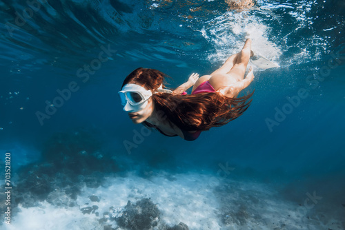 Woman swimmi ng in the tropical sea. Snorkeling with sexy woman photo