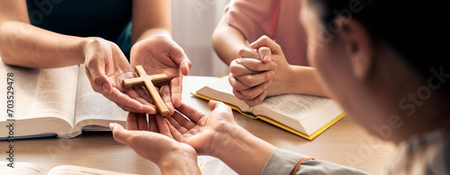 Фотография Close-up women prayer deliver holy bible book and holy cross to believer group