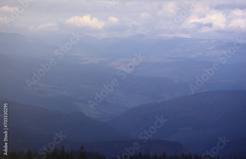 Morning view from the Dragobrat mountain peaks in Carpathian mountains  Ukraine. Cloudy and foggy landscape around Drahobrat Peaks in early morning