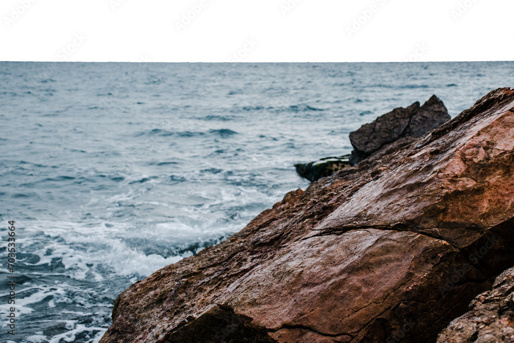 Winter sea with stones on the beach on transparent background. Underwater rock. Mediterranean sea.