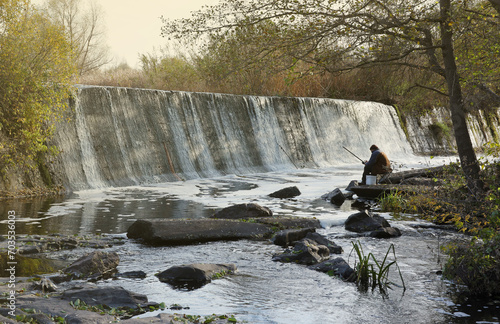 An abandoned dam, an artificial waterfall, the dam of the Butka HPP, is located up the river behind the bridge over the Hirsky Tikich river photo