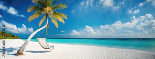 A hammock tied to a curved palm tree invites relaxation on a sunlit white sand beach in the Maldives, framed by a vivid blue sky. Pristine ocean with endless horizon. Serene background. photo
