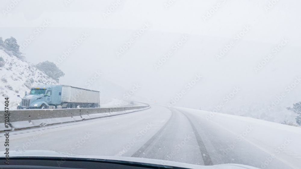 Obraz premium Braving a Winter Storm Driving Through Western Colorado