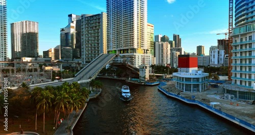 Yacht sailing under the drawbridge and another motor boat approaches the bridge. View of beautiful Miami, USA. photo