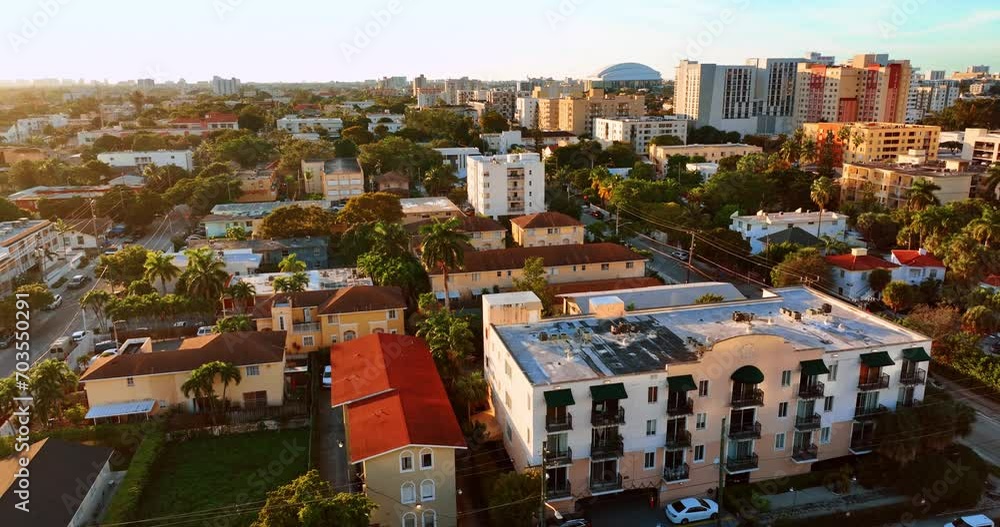 Flight above the houses in sunny Miami. Cozy houses and palm-trees in the residential area of American city. Flight above the houses in sunny Miami. Cozy houses and palm-trees in the residential area of American city.