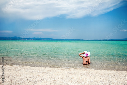 Fototapeta Naklejka Na Ścianę i Meble -  happy girl at sea in greece on sand nature