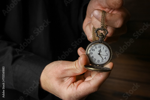 a pocket watch in the hands of a man