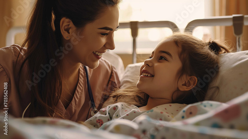 A woman is spendig quality time with her child laying a in hospital bed