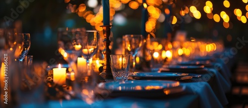 Blue candles and table setting create an atmospheric evening  35mm horizontal photo captures the beautiful event decor.