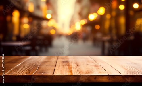 Lights' bokeh creates a blurred backdrop behind the empty wooden table