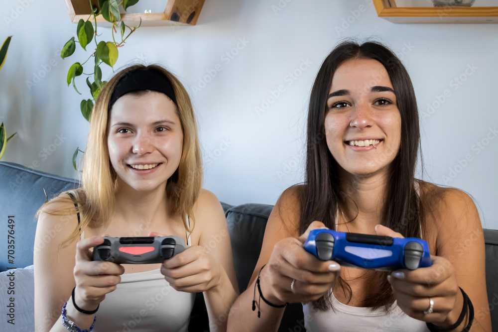 caucasian friends spend time together play console video games at home caucasian friends spend time together play console video games at home