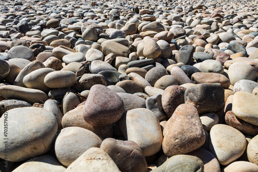 Abstract background of stones. Pebbles close-up, stone texture. Rounded stones close-up, slanted perspective view, soft focus Abstract background of stones. Pebbles close-up, stone texture. Rounded stones close-up, slanted perspective view, soft focus