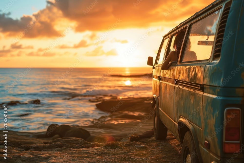 A young woman sitting inside van watching the sunset peacefully.