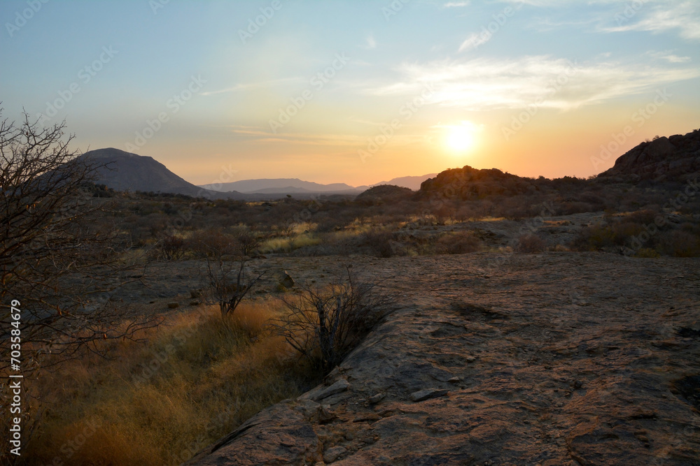 Sunset in the background among desert arid mountains. Natural landscape reserve. The wild nature
