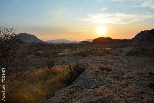 Sunset in the background among desert arid mountains. Natural landscape reserve. The wild nature