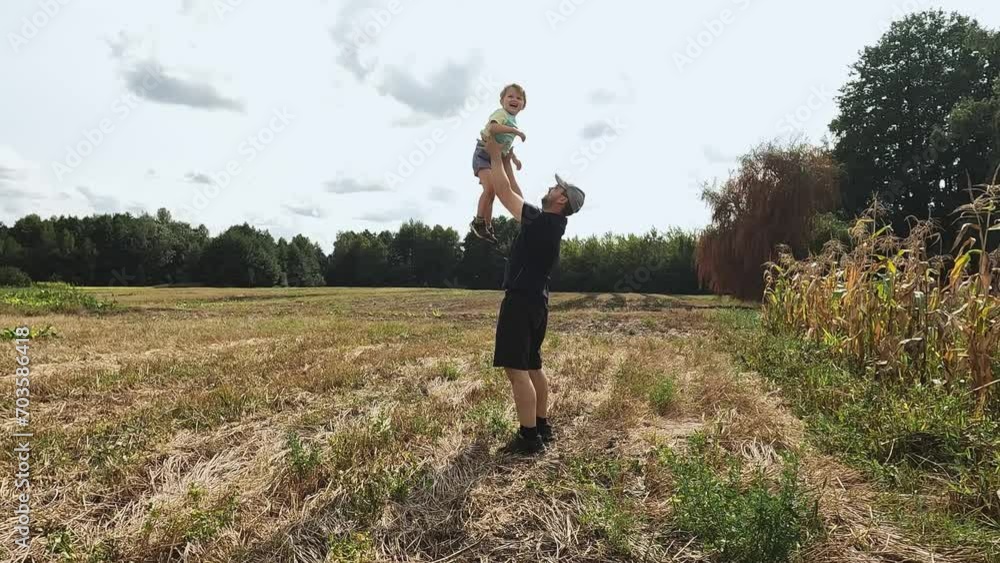 A joyful father throws his son up. High-quality shooting in 4K format. Concepts of a happy family, separation, distance, meeting, hugs, emotions, feelings, relationships, psychology, mortgage A joyful father throws his son up. High-quality shooting in 4K format. Concepts of a happy family, separation, distance, meeting, hugs, emotions, feelings, relationships, psychology, mortgage