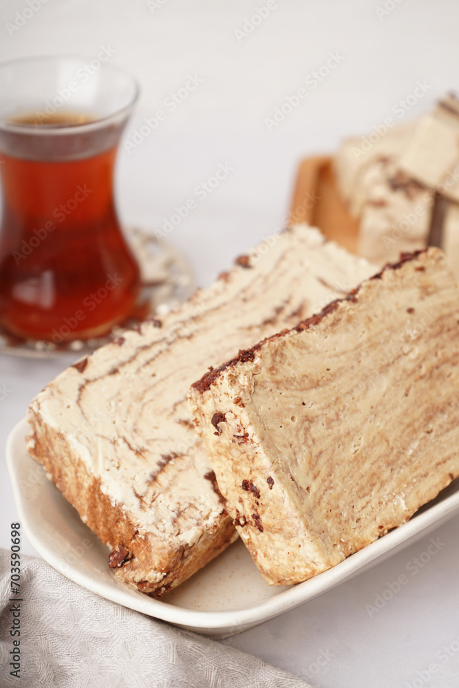 Bowl with pieces of tasty marble halva on light background Bowl with pieces of tasty marble halva on light background