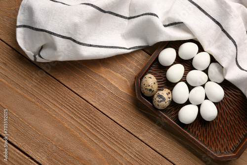 Tray of boiled quail eggs on wooden background