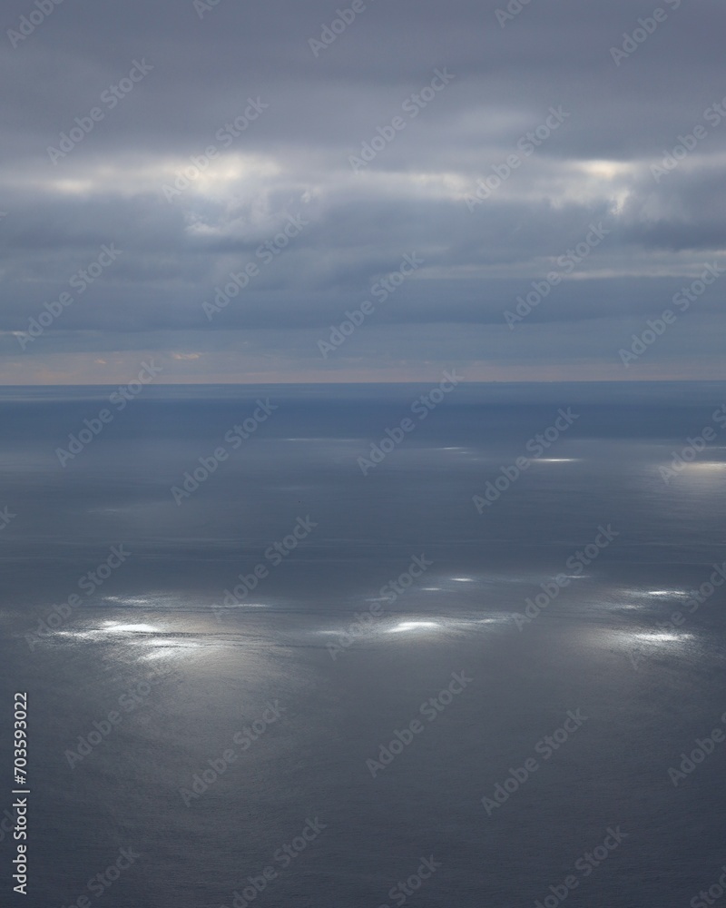 Clouds over the sea with sunstreak on the water surface