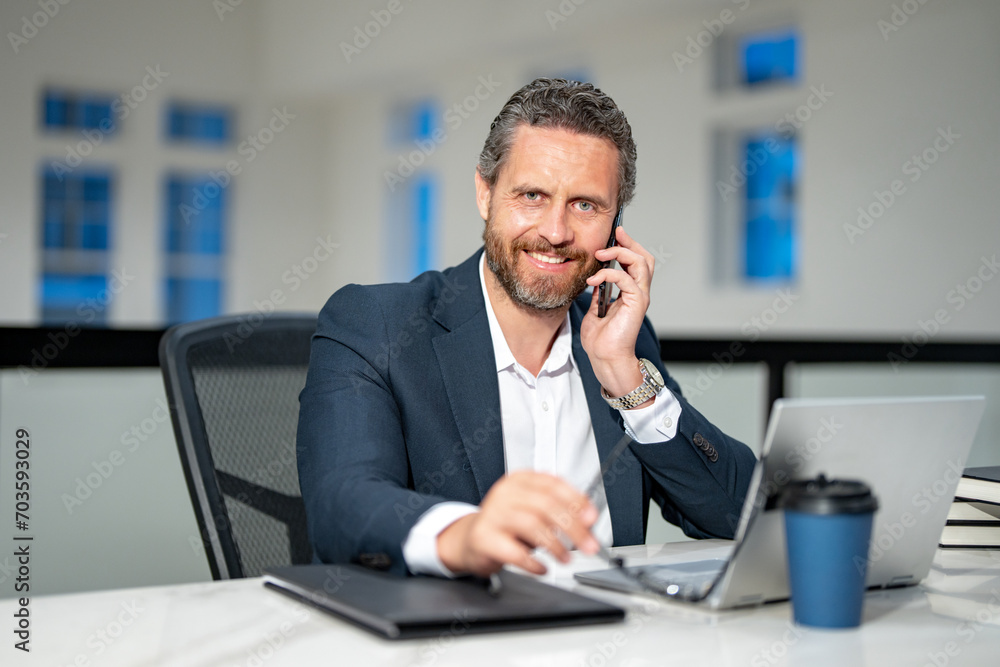 Business talk on phone. Ofice employee remote working in modern office. Businessman on remote meeting, working online in offices place. Business man using computer in office. Business talk on phone. Ofice employee remote working in modern office. Businessman on remote meeting, working online in offices place. Business man using computer in office.