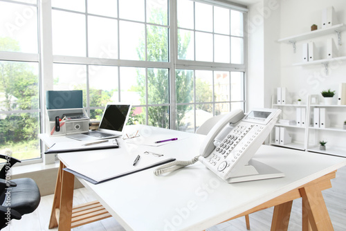 Workplace with telephone and laptop in HR's office