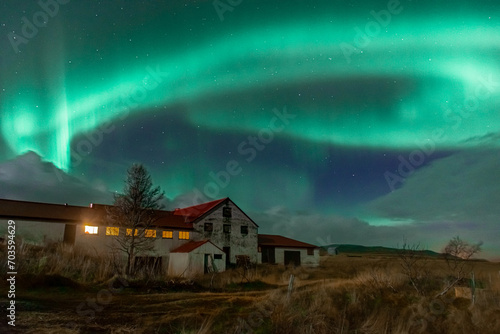 Northern Light,  spectacular Aurora borealis over a farm in Iceland