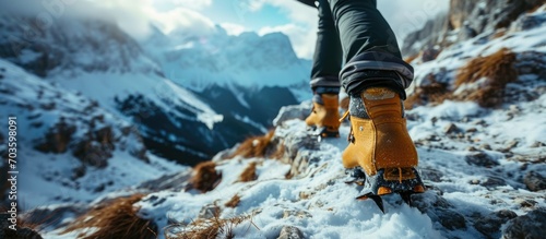 Female mountaineers wear crampons on their boots when climbing snowy mountains. photo