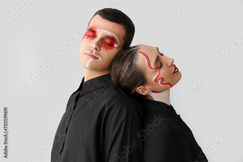 Young couple with painted f...
