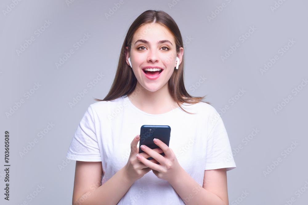 Young woman using phone device gadget app isolated over studio background. Girl holding a smartphone, chatting by mobile phone. Girl using phone, studio portrait. Woman makes telephone call on phone. Young woman using phone device gadget app isolated over studio background. Girl holding a smartphone, chatting by mobile phone. Girl using phone, studio portrait. Woman makes telephone call on phone.