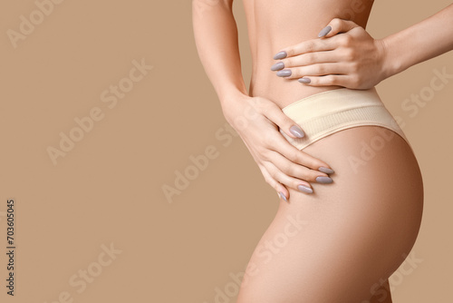 Wallpaper Mural Young woman in panties on beige background, closeup. Plastic surgery concept Torontodigital.ca