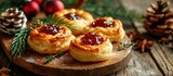 Cheese and jam puff pastry wheels, Christmas appetizers on a wooden board.