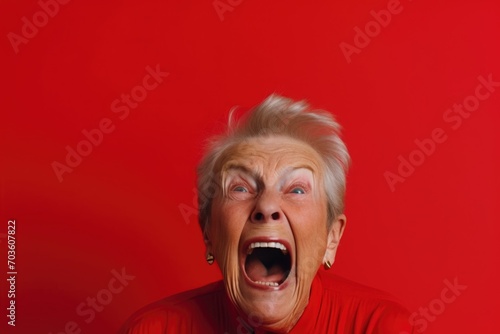 Upset old, adult woman, female in red t shirt screaming and crying with opened mouth and closed eyes against © Svetlana