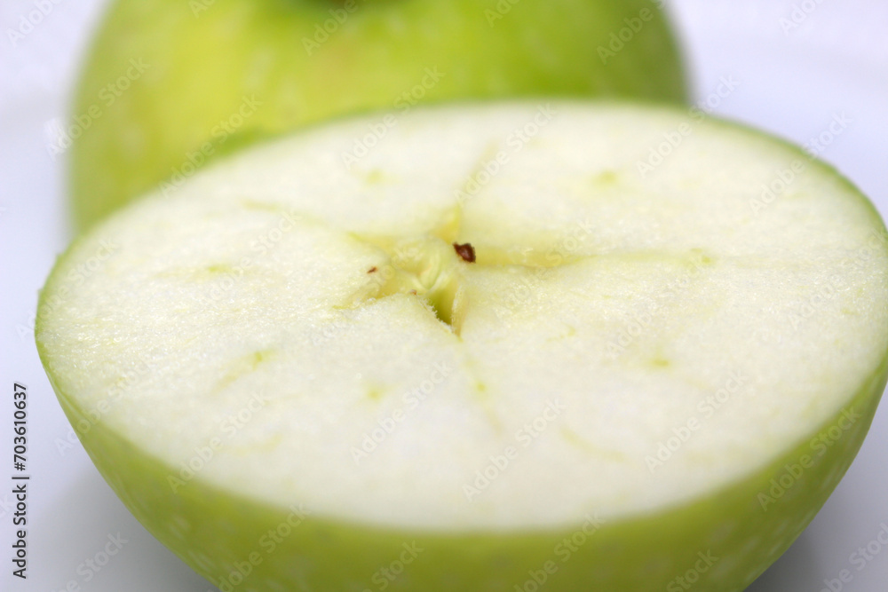 green apple close up. apple with selective focus. green apple cut in half.