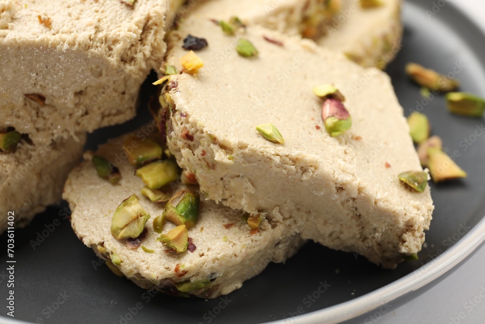 Tasty pistachio halva on white table, closeup