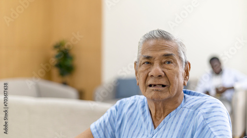 Old man sitting on a wheelchair in a health care office with happy face