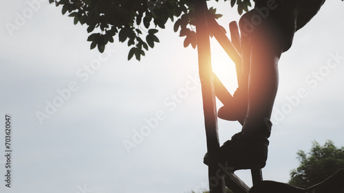 Close up legs of businessman or kid stepping up stair or fixed ladder, business growth, go up, success, grow up business step by step concept. Climbing to goal or freedom life. photo