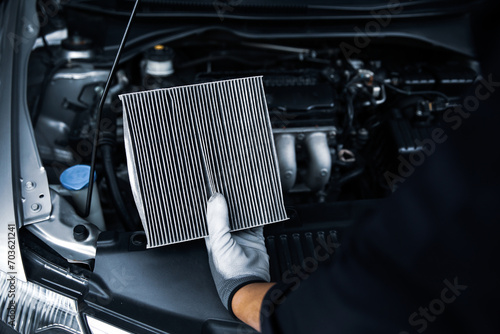 Hand mechanic holding car air conditioner filter for check and clean dirty or fix repair heat have engine problem or replace new change air filter.