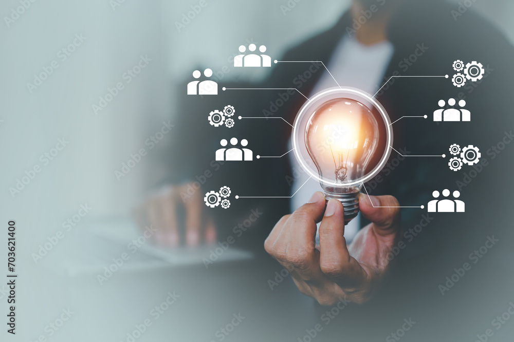 Hand and light bulb for creative idea concept or innovation of technology in analyzing global marketing online business data management services to target growth concept. Hand and light bulb for creative idea concept or innovation of technology in analyzing global marketing online business data management services to target growth concept.
