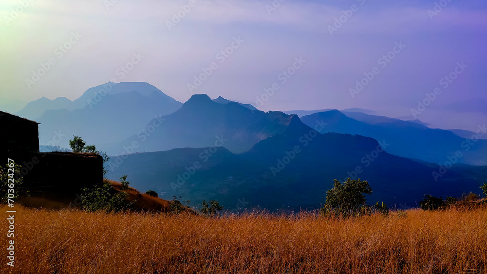 Grass and sahyadri mountains view from the raigad fort in maharashtra in India 