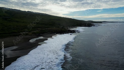 Landscape and  waves on a black sand beach at Reunion Island
