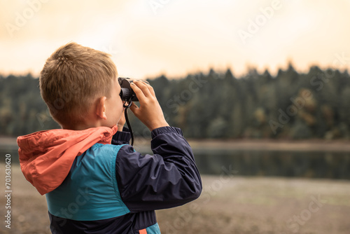 boy with binoculars exploring nature wildlife 