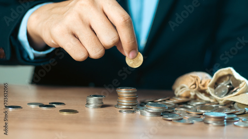 ฺBusinessman picking up coins money saving concept savings for accounting business finance. Businessman with stacking gold coins, stacking bitcoins