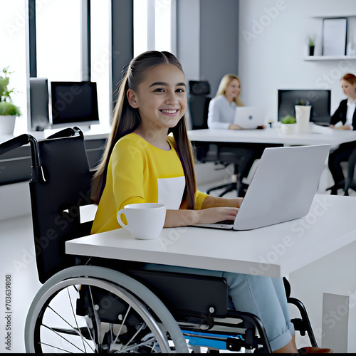 young girl  in wheelchair working in office photo