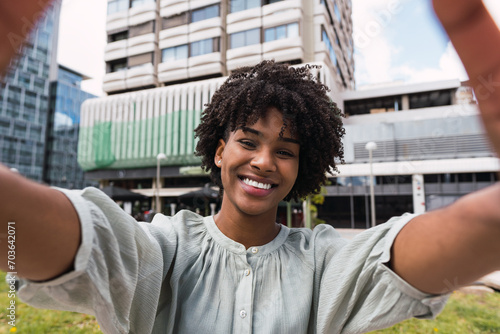 Portrait, selfie smile and happy black woman taking pictures to remember memory, social media or profile picture. Face, beauty and female from South Africa talking photo outdoors in nature or park