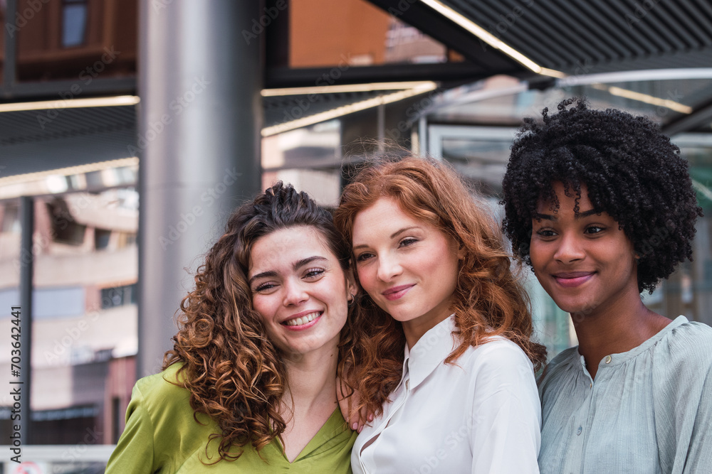 Fototapeta premium Smiling team of diverse businesspeople standing together outside office building