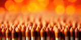 Cluster of matchsticks with bright orange tips, ready for ignition